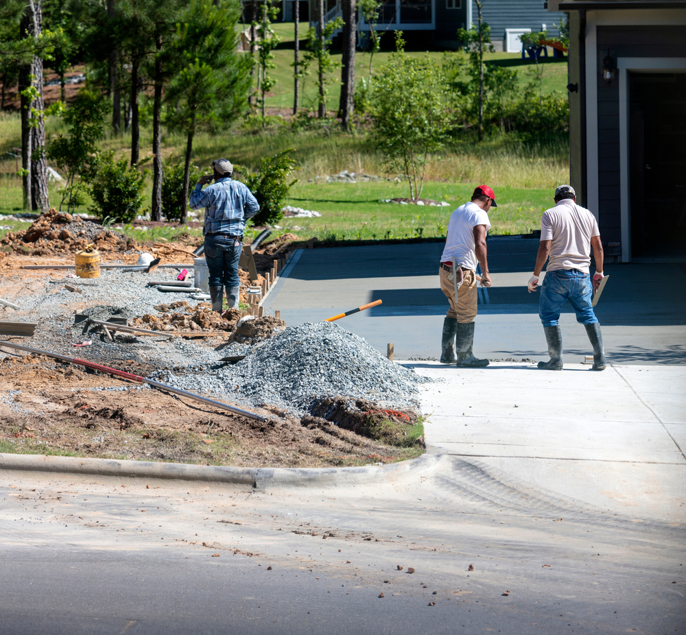 Workers resurfacing a driveway for a home