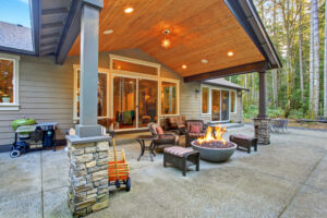 New modern patio with a fire place and tall trees on the sides